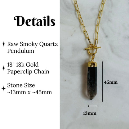 A raw smoky quartz pendant necklace on a gold paperclip chain, shown with dimension labels indicating a 45mm stone length and 13mm width, alongside text detailing the materials and measurements.