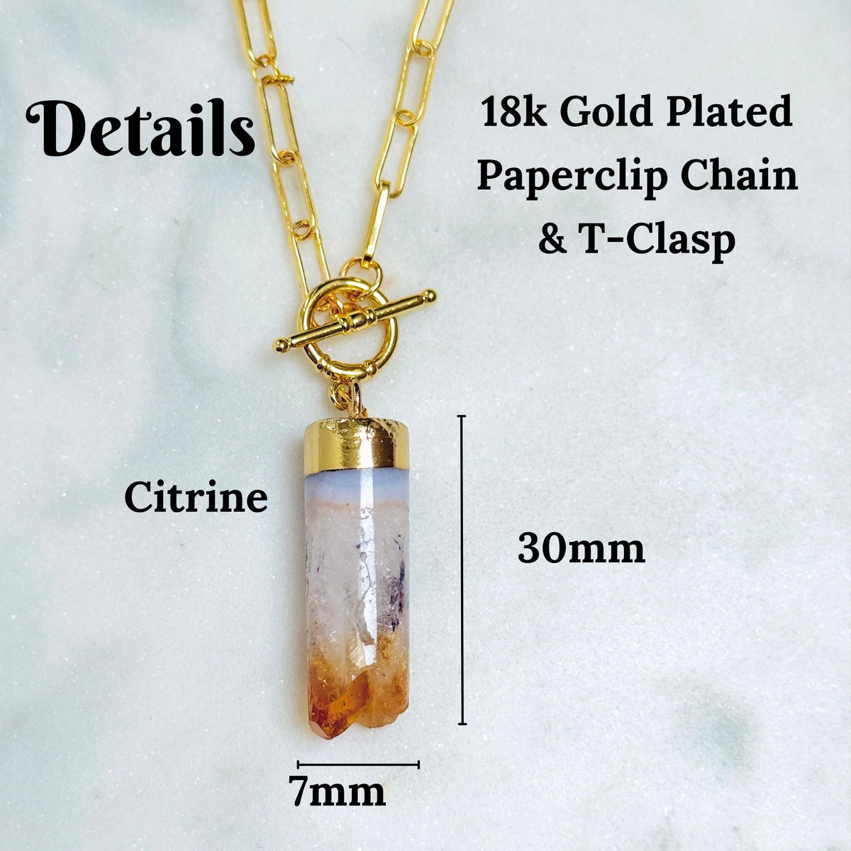 Citrine crystal pendant necklace with a 18k gold-plated paperclip chain and toggle clasp, shown with dimension labels indicating 30mm length and 7mm width on a light marble background.