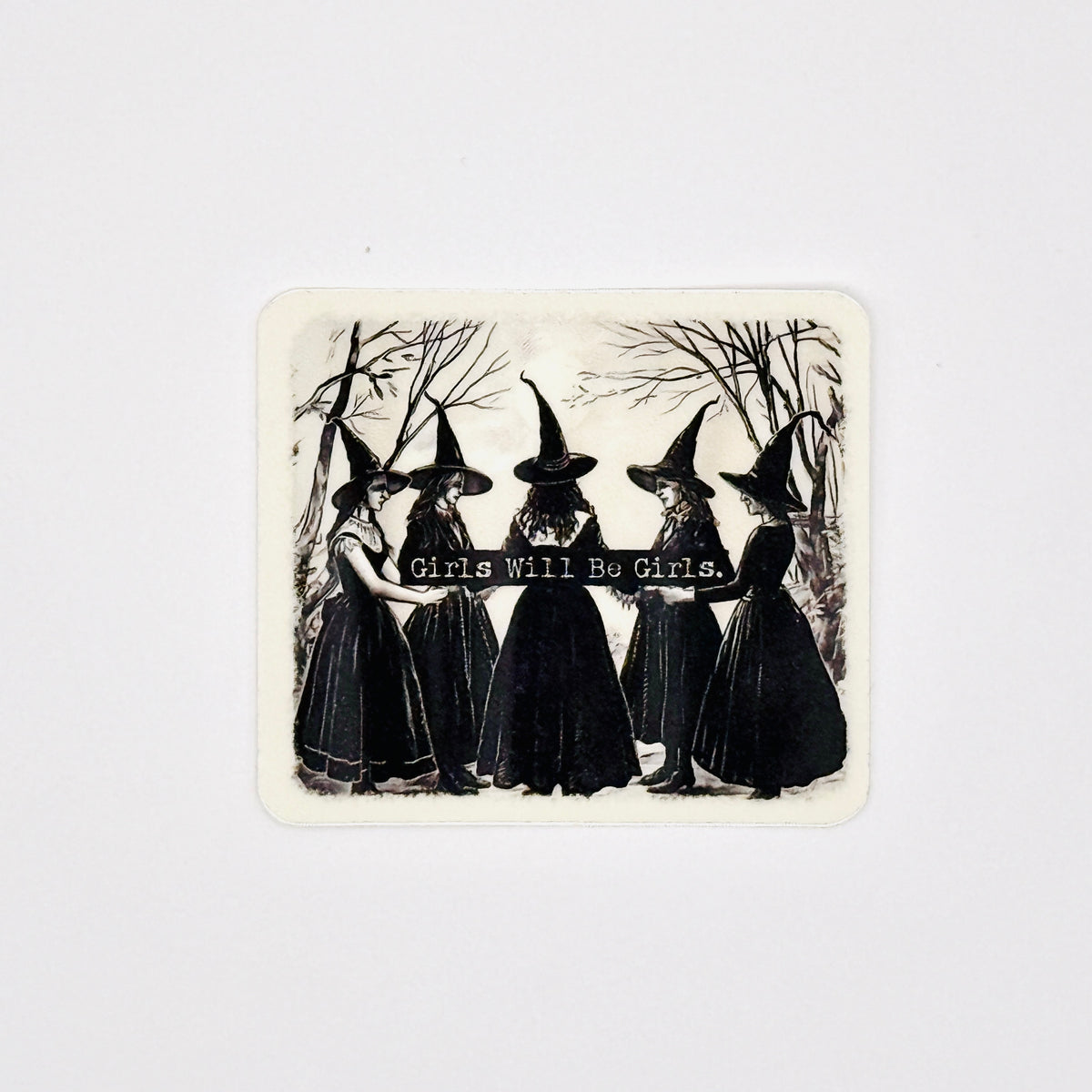 A square sticker with rounded corners featuring a vintage black and white illustration of five girls in witch hats holding a banner that reads 'Girls Will Be Girls.' against a light gray background.