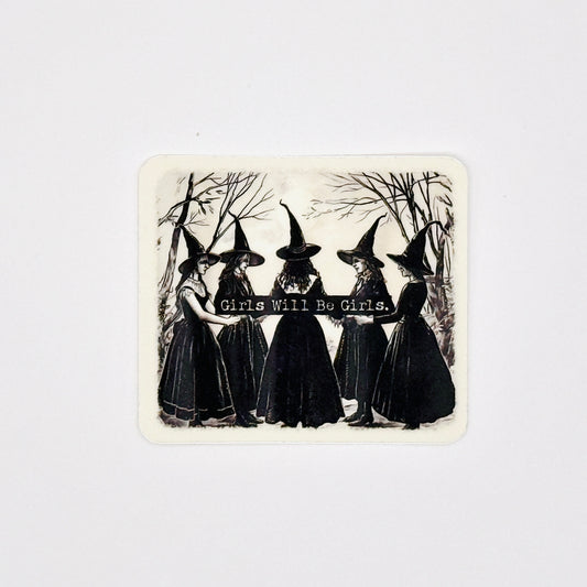 A square sticker with rounded corners featuring a vintage black and white illustration of five girls in witch hats holding a banner that reads 'Girls Will Be Girls.' against a light gray background.