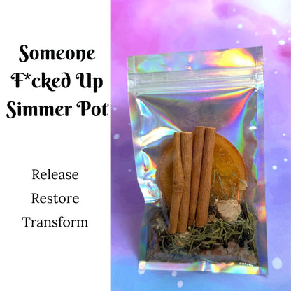 A clear holographic zip pouch containing dried herbs, cinnamon sticks, and a round orange-brown piece, shown on a purple and blue gradient background with text reading 'Someone F*cked Up Simmer Pot' and 'Release Restore Transform'.