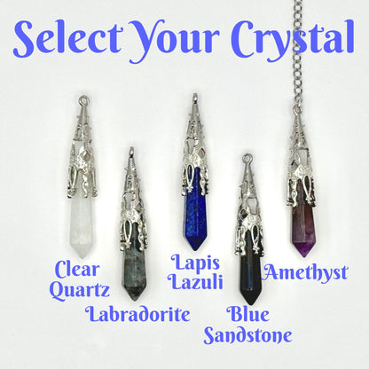 A product selection graphic showing four crystal pendant necklaces with silver filigree settings and labeled stones: Clear Quartz, Lapis Lazuli, Blue Sandstone, and Amethyst. The image includes the text 'Select Your Crystal' at the top and stone names at the bottom on a white background.